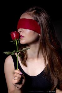 model with red rose low key portrait